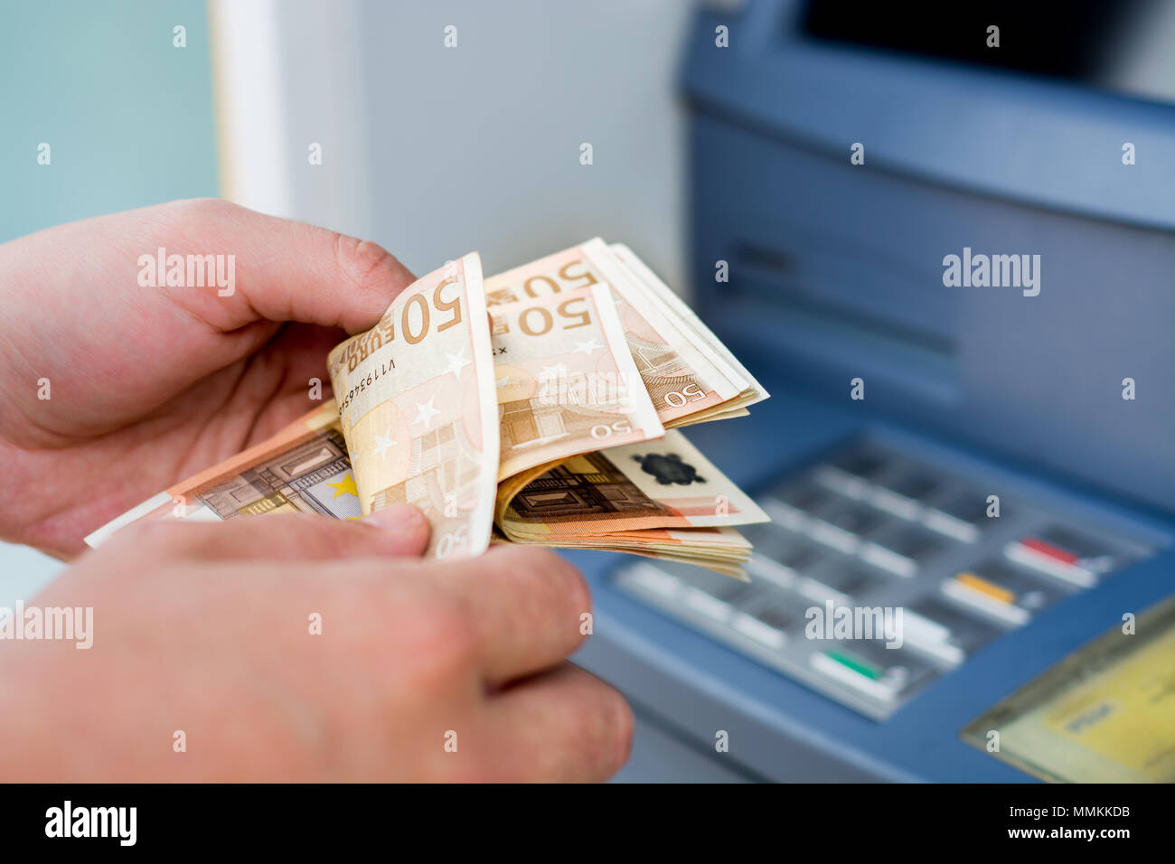 Taking money out of the ATM Stock Photo Alamy