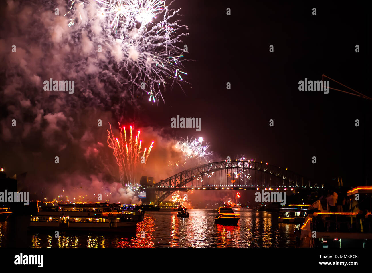 Sydney, Australia - January 1, 2015: Fireworks with boats parade at Harbour Bridge in Sydney bay at midnight for the new years eve 2015, shot from a b Stock Photo