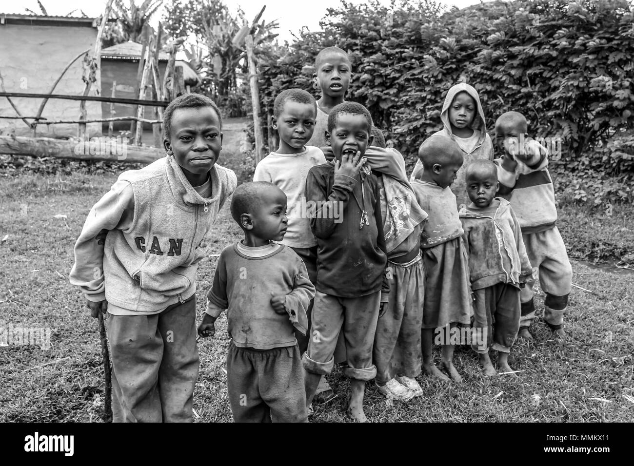 Arusha, Tanzania.- January 2, 2013: Children of Ilkidinga, Waarusha Masai village on the slopes of Mount Meru. Black and white. Stock Photo