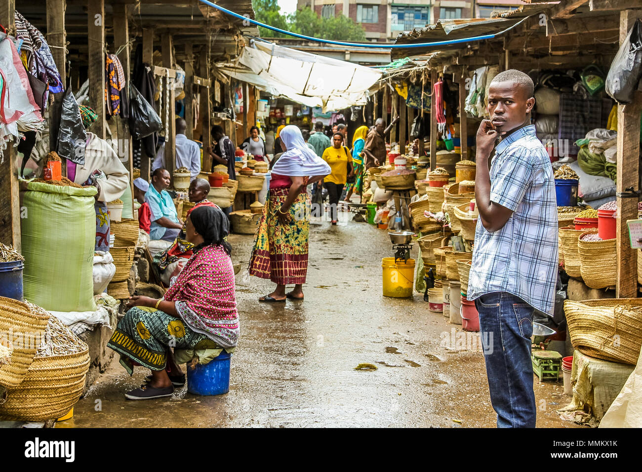 Arusha, Tanzania, Africa - January 2, 2013: Teenager on the road within  market of the town Stock Photo