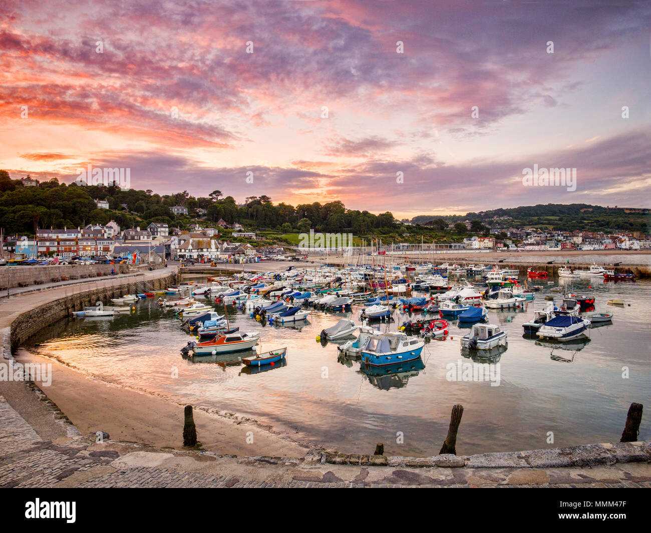 The historic harbour at Lyme Regis, Dorset, England, on a summer evening. Stock Photo
