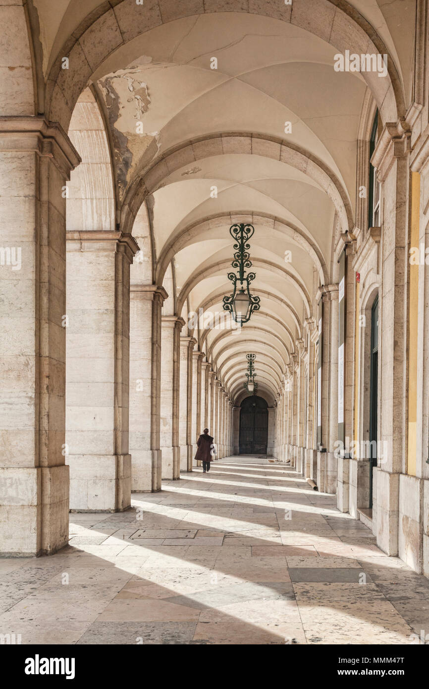 7 March 2018: Lisbon, Portugal - Colonnade in Praca de Comercio, Lisbon, Portugal, one person walking. Stock Photo