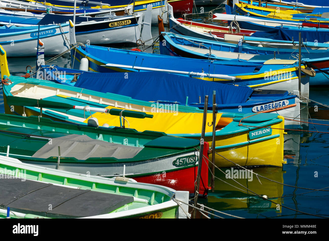 Small colorful wooden fishing boats named Pointus moored in old