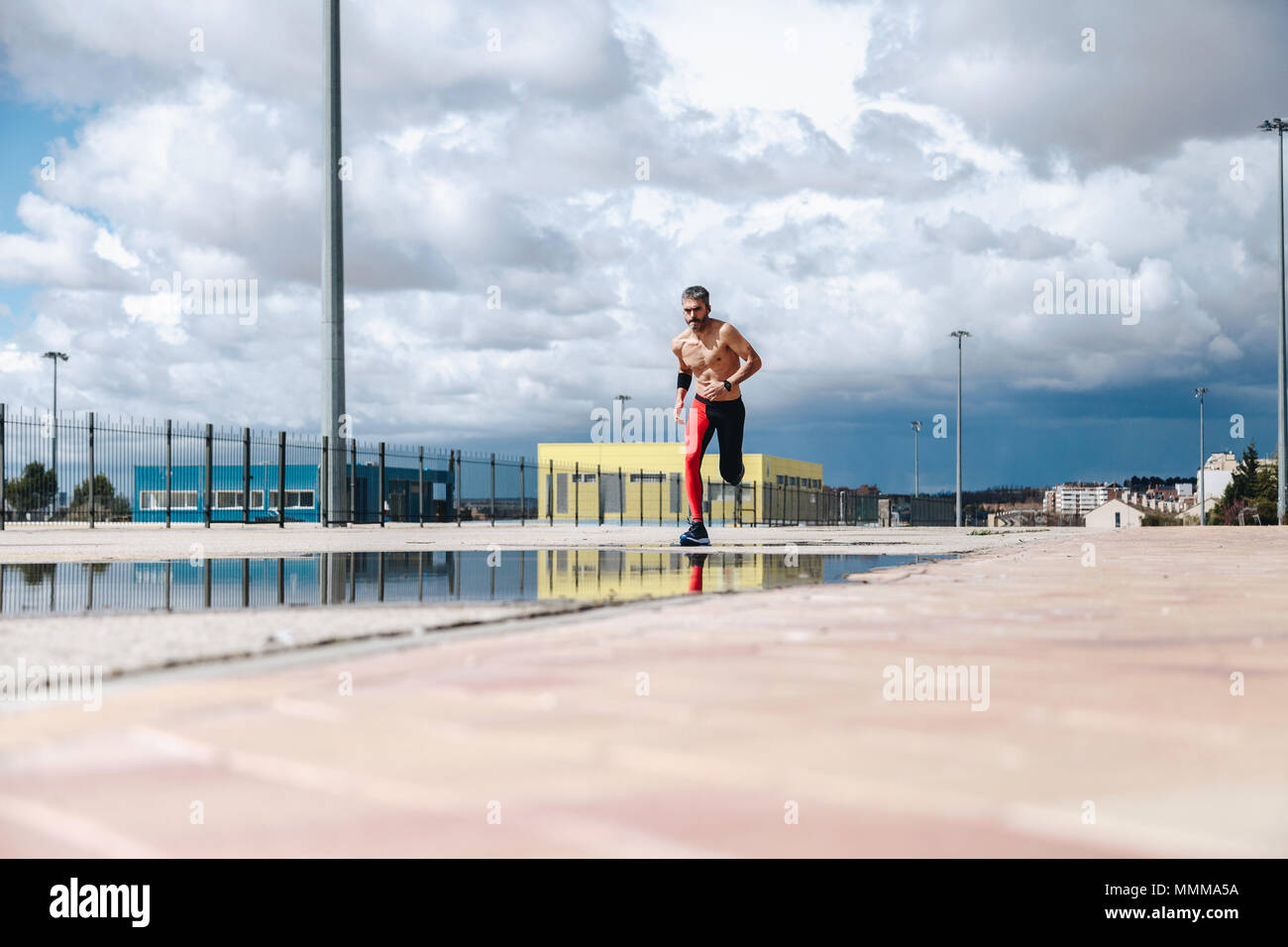 Young man running on urban hi-res stock photography and images - Alamy