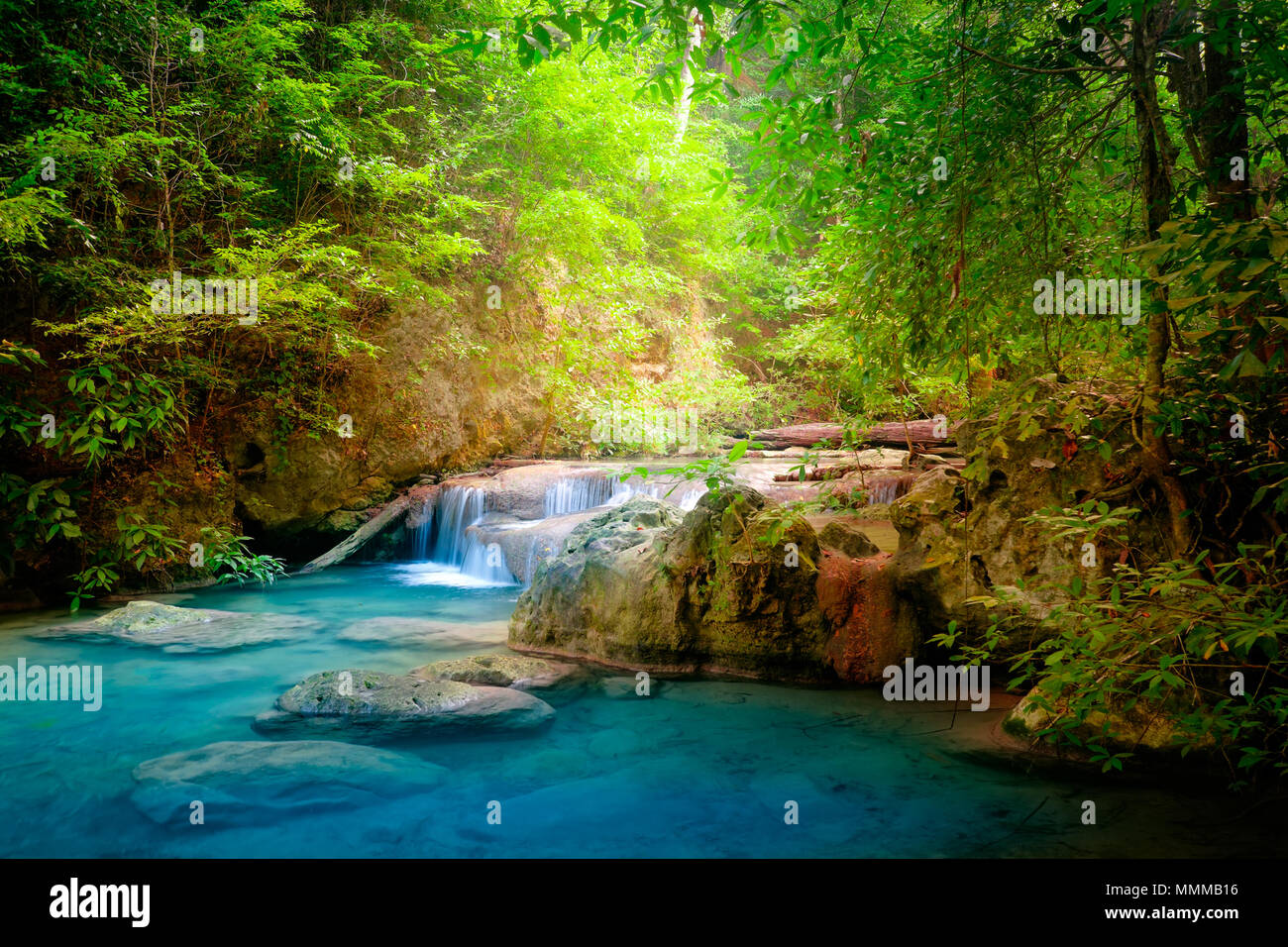 Jangle landscape with flowing turquoise water of Erawan cascade waterfall at deep tropical rain forest. National Park Kanchanaburi, Thailand Stock Photo