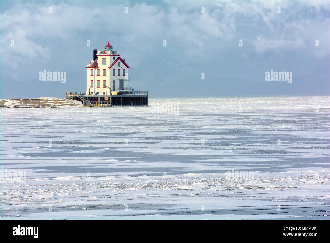 The Lorain Lighthouse is a historic landmark on the shores of Lake Erie, one of the Great Lakes. Seen here in winter with snow and ice. Stock Photo