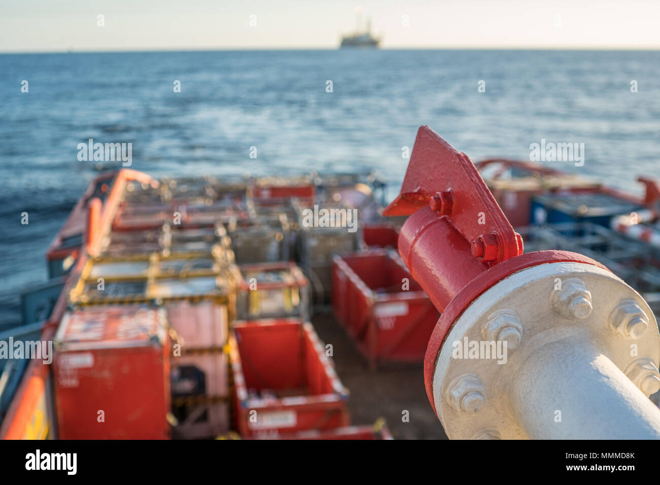 Closeup view of vessel fire fighting system, which covers main deck of offshore supply vessel at sea . Cargo containers are on background. Stock Photo