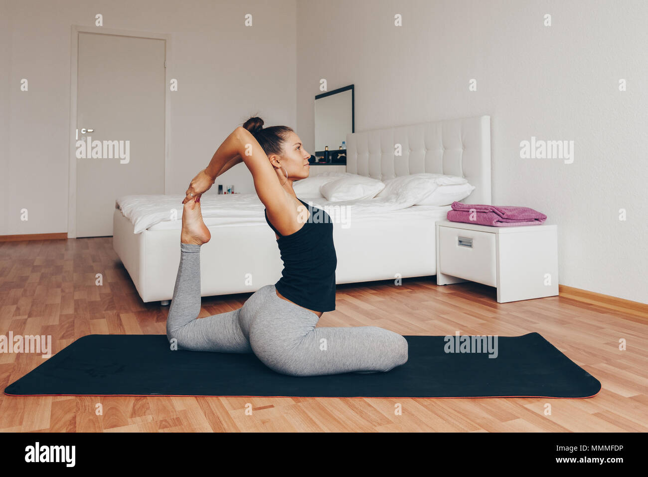 Young woman meditating indoors. A series of yoga poses. lifestyle concept Stock Photo
