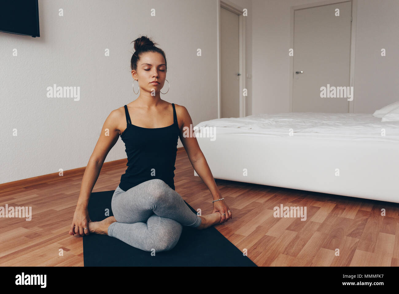 Young woman meditating indoors. A series of yoga poses. lifestyle concept. Stock Photo