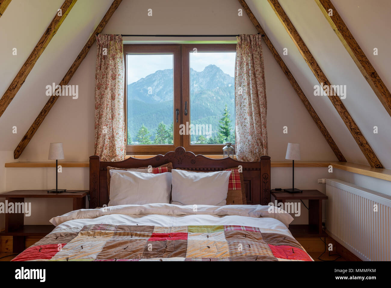a window in a palm on the top floor of a rural house with a beautiful view of the mountains Stock Photo