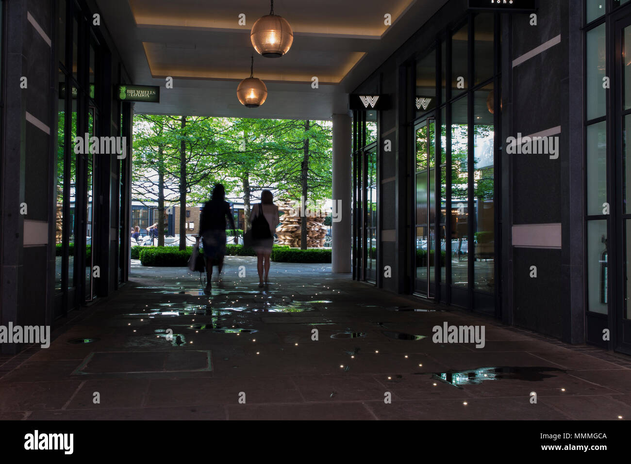 People walk through Denman Place towards Ham Yard Hotel in Soho, London Stock Photo