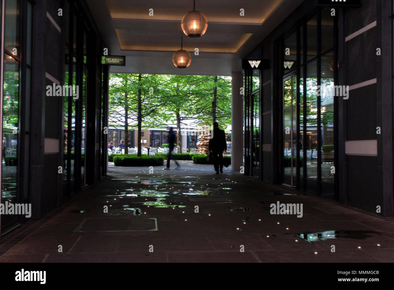 People walk through Denman Place towards Ham Yard Hotel in Soho, London Stock Photo