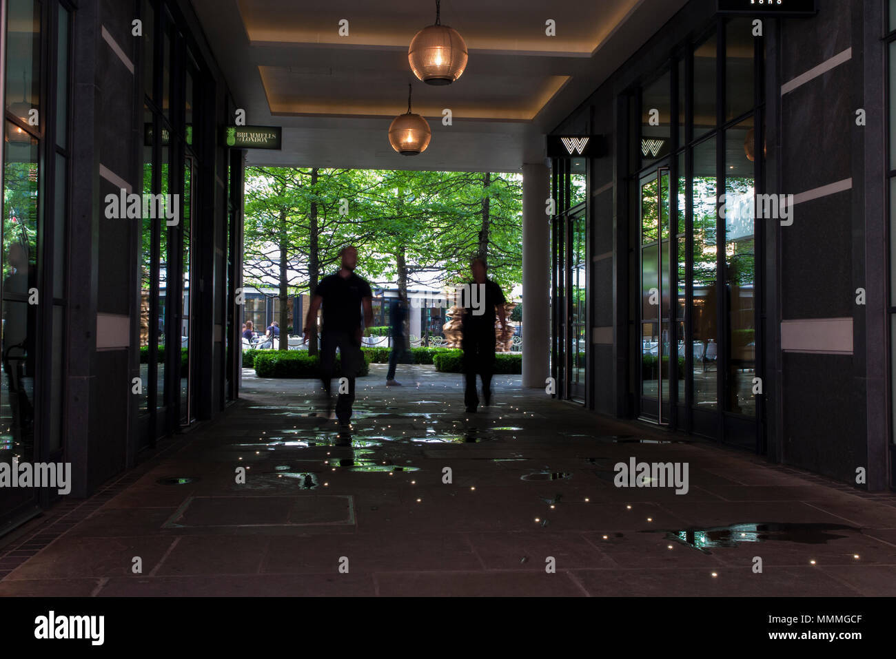 People walk through Denman Place towards Ham Yard Hotel in Soho, London Stock Photo