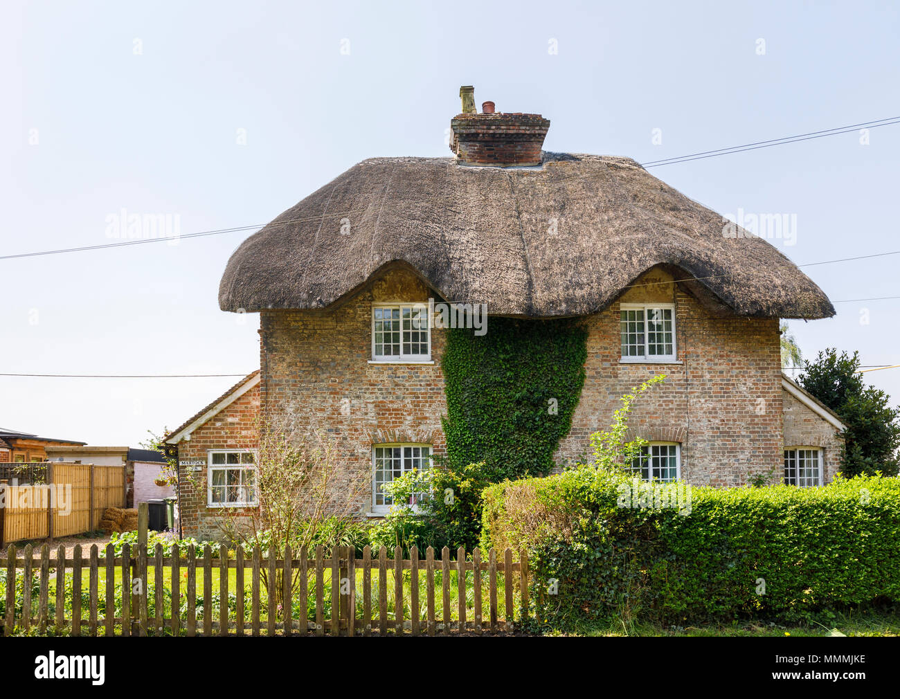Attractive local architectural style traditional thatched cottage in East Stratton, a small village near Winchester in Hampshire, southern England Stock Photo