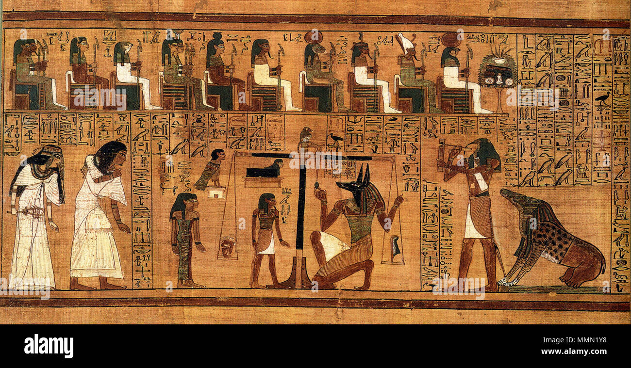 .  English: The Weighing of the Heart from the Book of the Dead of Ani. At left, Ani and his wife Tutu enter the assemblage of gods. At center, Anubis weighs Ani's heart against the feather of Maat, observed by the goddesses Renenutet and Meshkenet, the god Shay, and Ani's own ba. At right, the monster Ammut, who will devour Ani's soul if he is unworthy, awaits the verdict, while the god Thoth prepares to record it. At top are gods acting as judges: Hu and Sia, Hathor, Horus, Isis and Nephthys, Nut, Geb, Tefnut, Shu, Atum, and Ra-Horakhty.  . Photograph published 2001; artwork created c. 1300  Stock Photo
