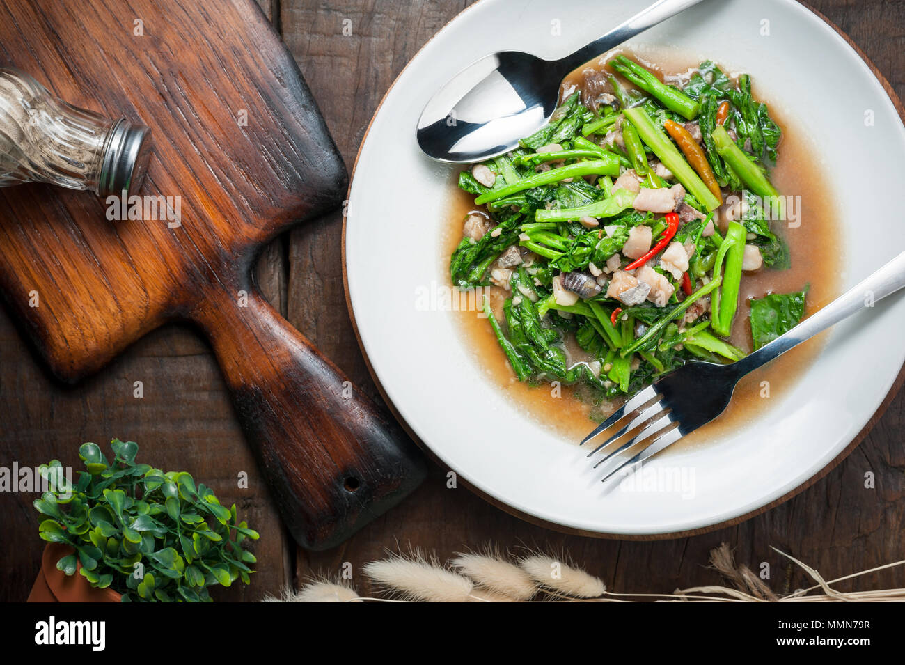 Thai food Stirfried kale with sundried salted fish on wooden table