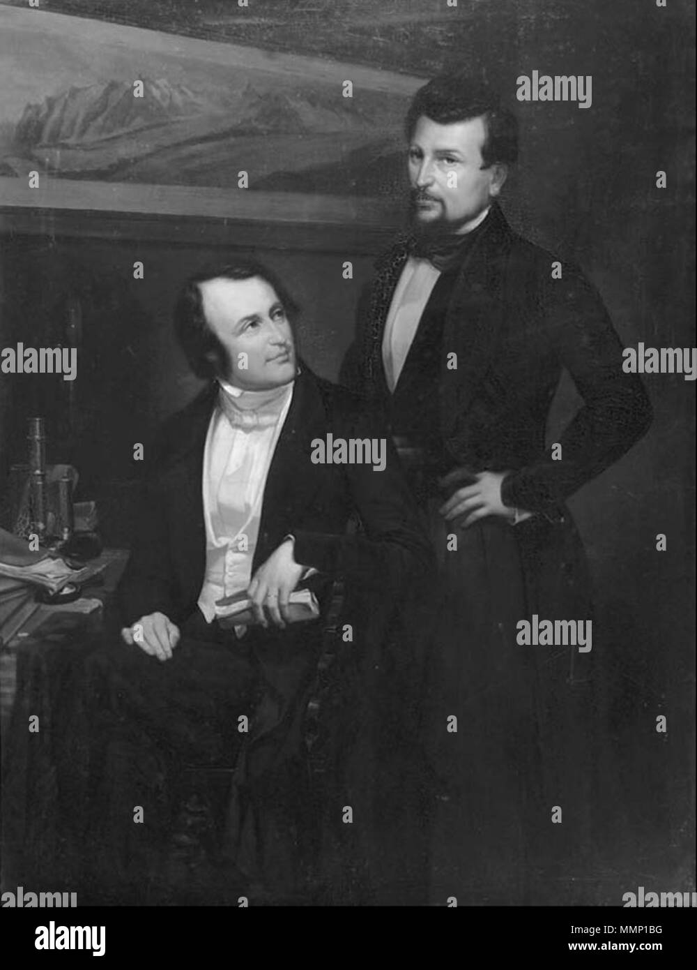 . English: Black-and-white reproduction of an oil painting showing Louis Agassiz (seated) and Pierre Jean Édouard Desor (standing). In the background on the wall the painter shows Jacques Bourkhardt's (1811–1867) painting Panorama de la mer de glace du Lauteraar et du Finsteraar–Hôtel des Neuchâtelois, 1842. The original of Berthoud's painting is at the Musée d’Art et d’Histoire Neuchâtel, Switzerland (Inventory no. 762).  . 19th century. Fritz Berthoud (1812–1890) 29 Agassiz and Desor by Berthoud Stock Photo
