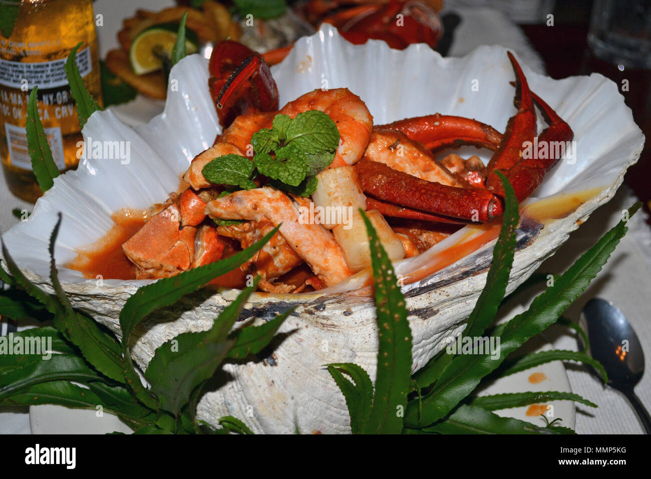 Gourmet seafood entree dish served inside a real bivalve shell, Pohnpei, Federated States of Micronesia Stock Photo