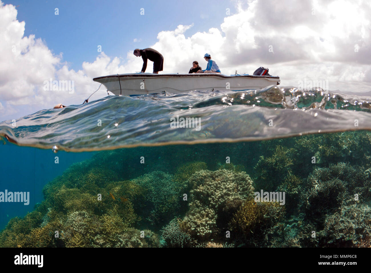 People enjoying the outdoors a small skiff over a pristine  tropical reef, Pohnpei, Federated States of Micronesia Stock Photo