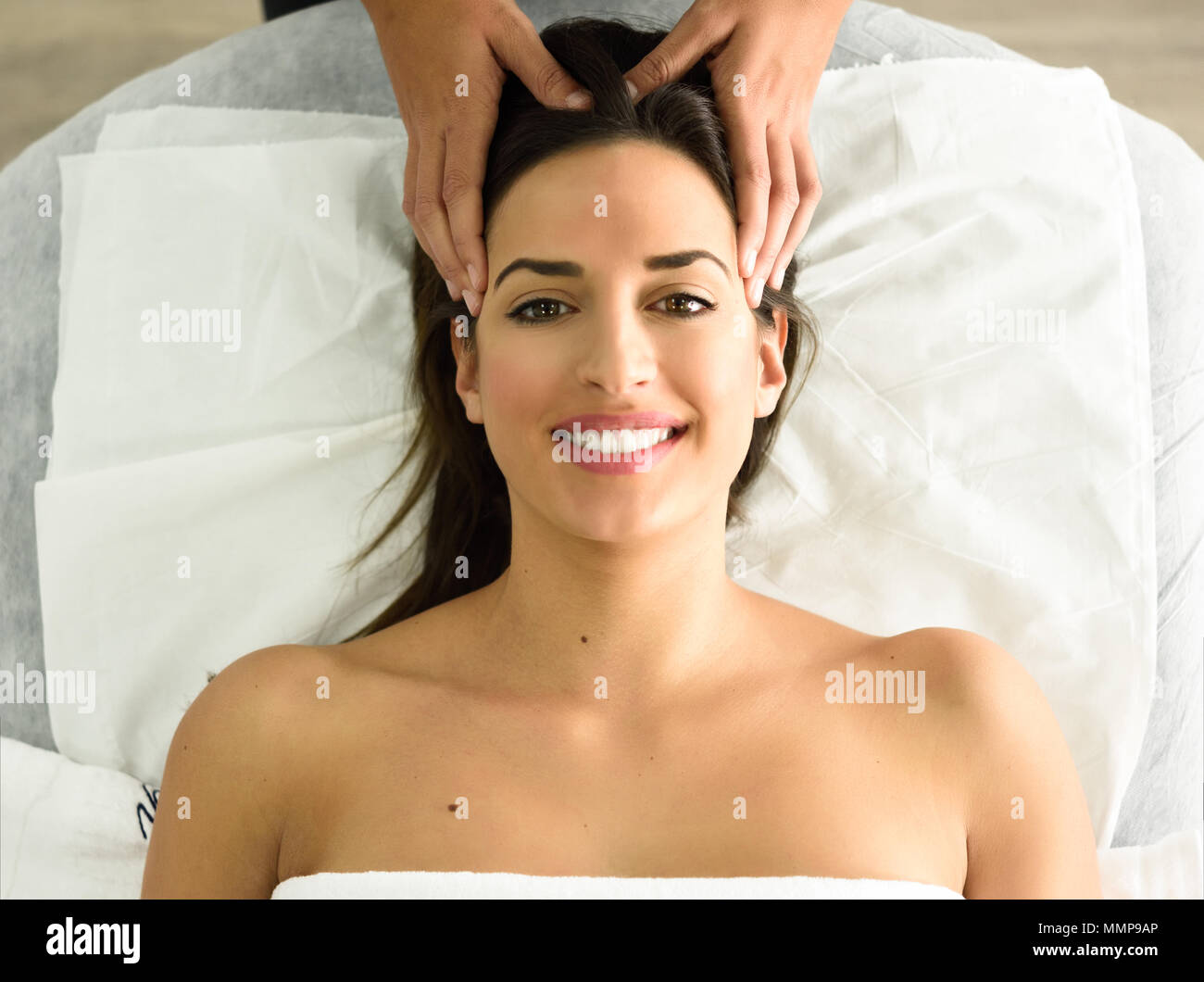 Top View Of Young Caucasian Smiling Woman Receiving A Head Massage In A