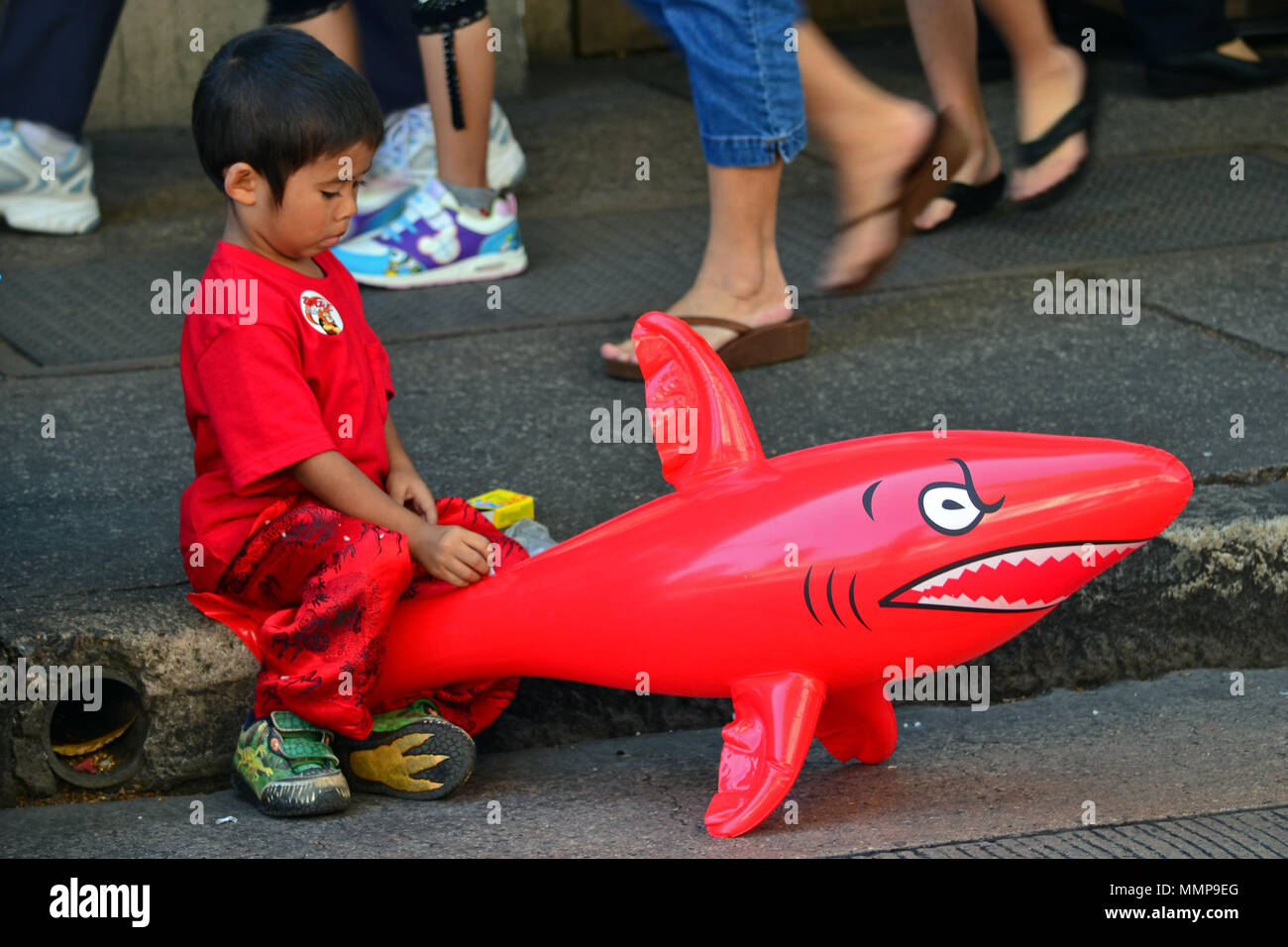 Boy holds a shark balloon on a sidewalk during Lunar New Year celebration,  Oahu, Hawaii, USA Stock Photo - Alamy