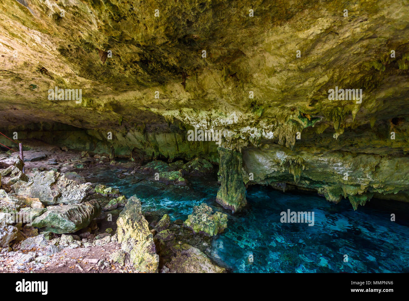Cenote Dos Ojos in Quintana Roo, Mexico. People swimming and snorkeling in clear water. This
