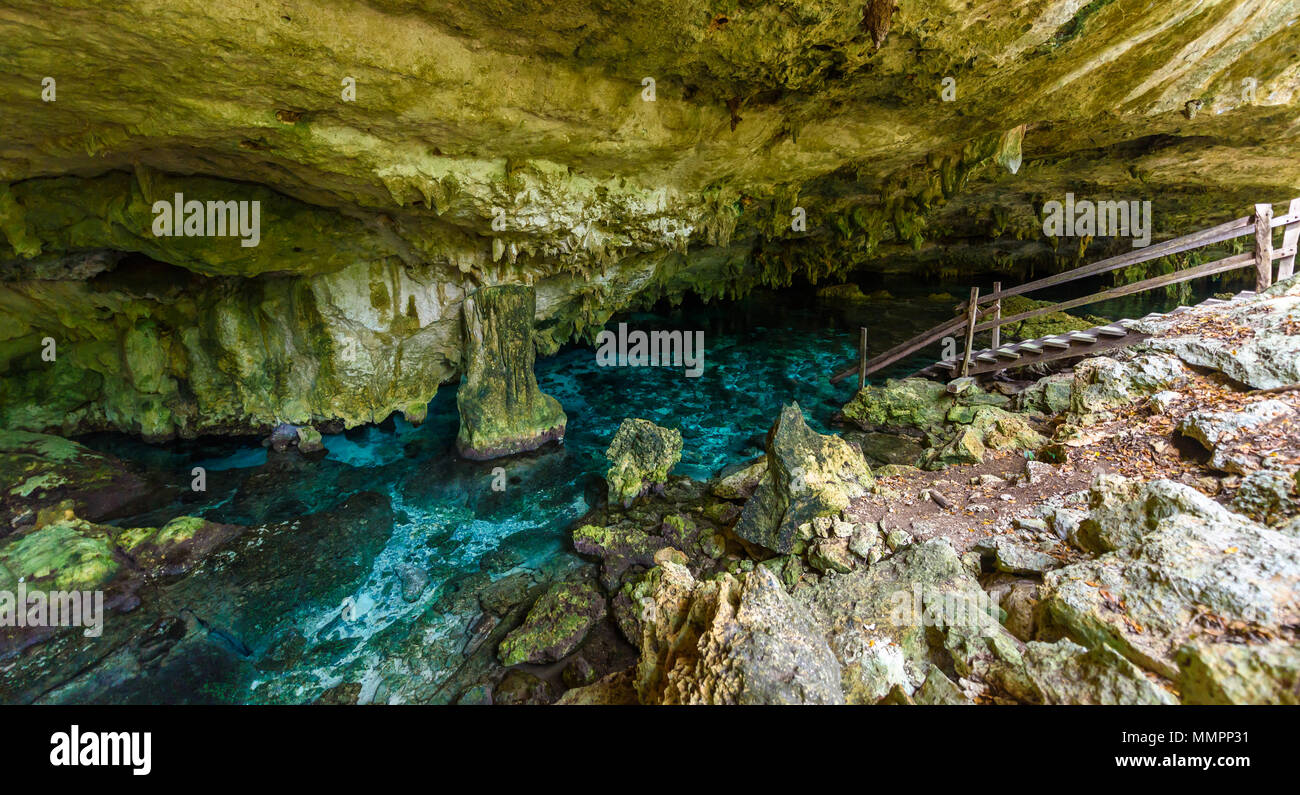 Cenote Dos Ojos in Quintana Roo, Mexico. People swimming and snorkeling in clear water. This