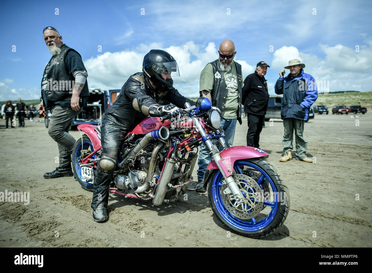 A competitor on motorbike takes part in the annual UK, European and World land speed event organised by Straightliners, at Pendine Sands, Wales, where riders and drivers of all vehicle types compete in classes for top speeds over a measured mile on the beach. Stock Photo