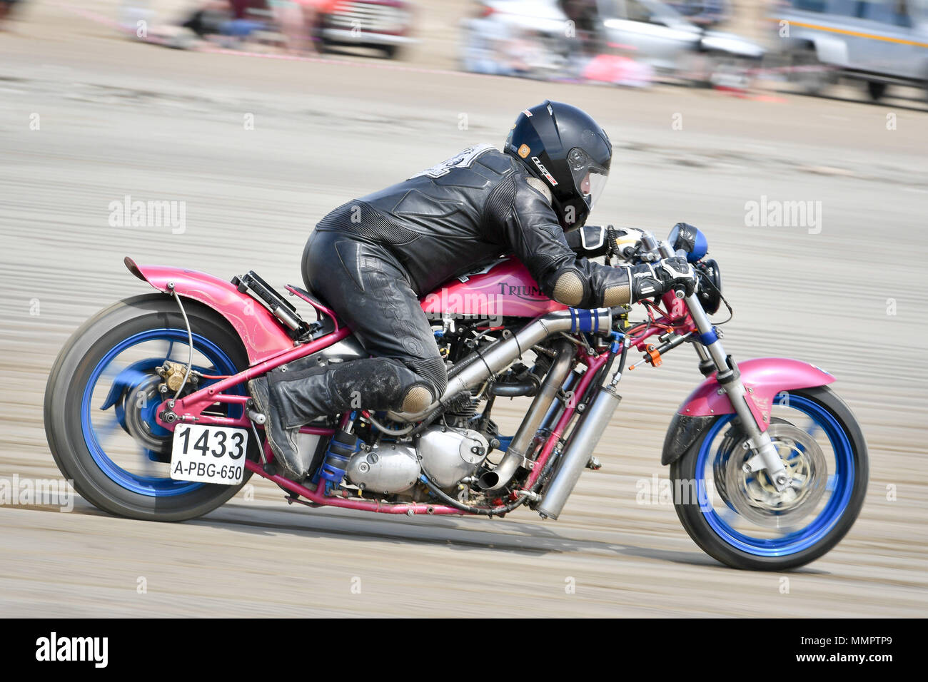 A competitor on motorbike takes part in the annual UK, European and World land speed event organised by Straightliners, at Pendine Sands, Wales, where riders and drivers of all vehicle types compete in classes for top speeds over a measured mile on the beach. Stock Photo