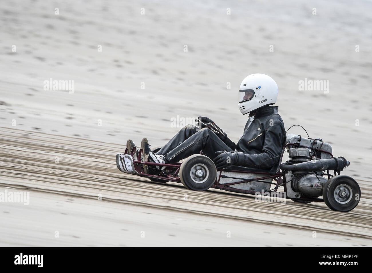 A competitor on a go-kart takes part in the annual UK, European and World land speed event organised by Straightliners, at Pendine Sands, Wales, where riders and drivers of all vehicle types compete in classes for top speeds over a measured mile on the beach. Stock Photo