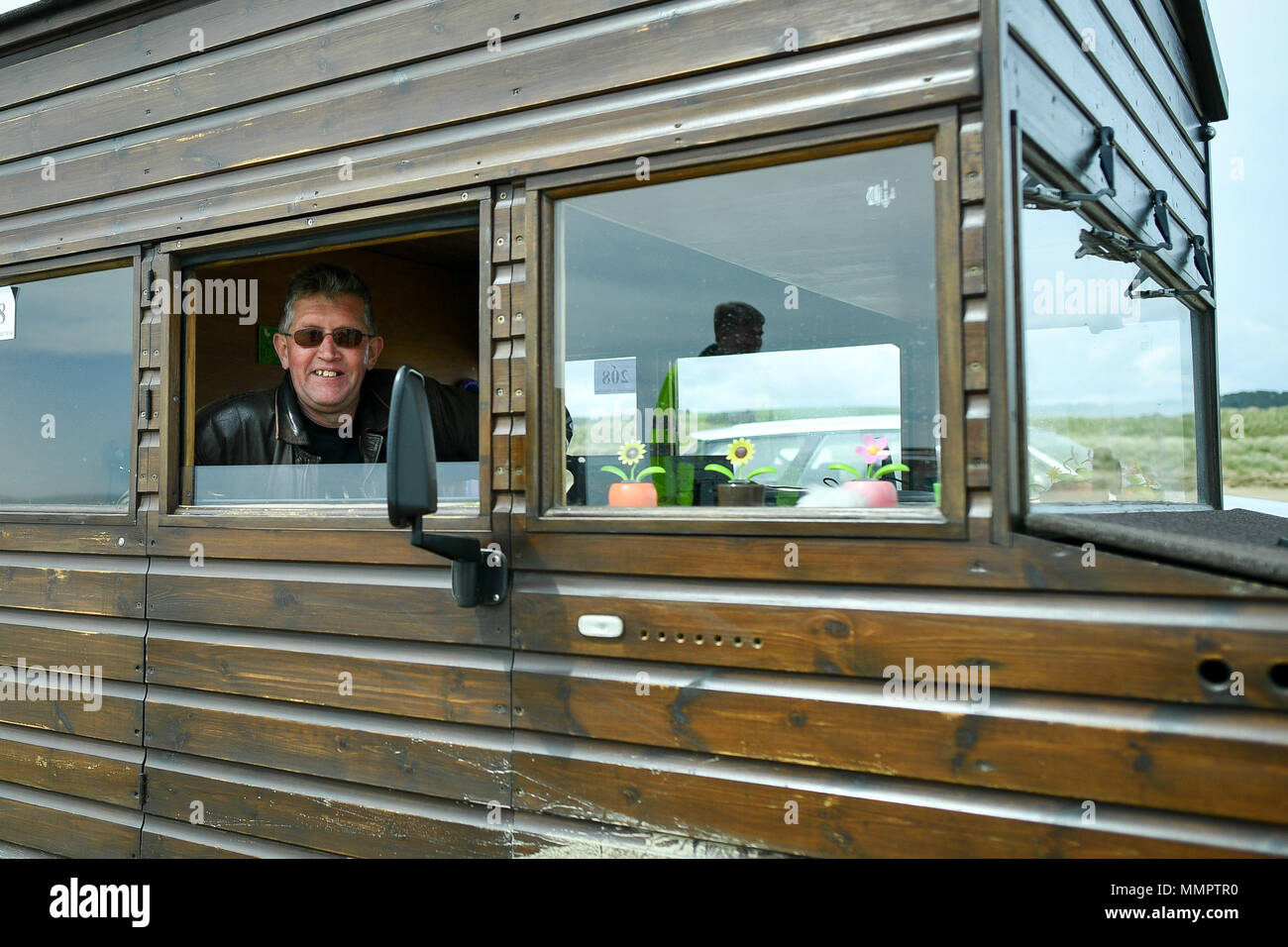 Kevin Nicks, the driver of the Fastest Shed which broke the 100mph mark, sits in the vehicle after his run in the annual UK, European and World land speed event organised by Straightliners, at Pendine Sands, Wales, where riders and drivers of all vehicle types compete in classes for top speeds over a measured mile on the beach. Stock Photo