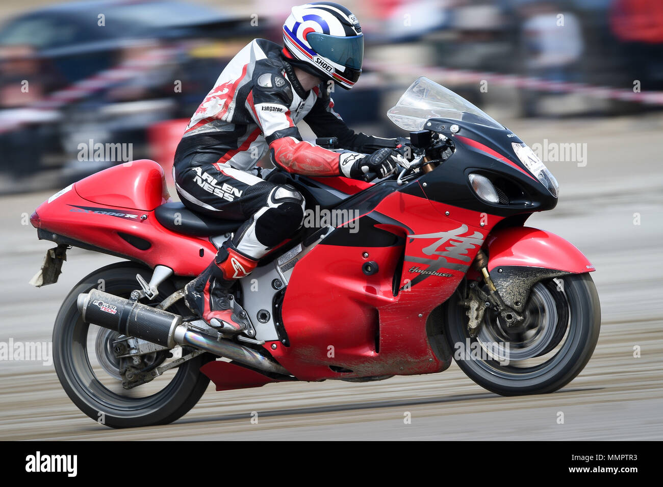 A competitor on a Suzuki Hayabusa motorbike takes part in the annual UK, European and World land speed event organised by Straightliners, at Pendine Sands, Wales, where riders and drivers of all vehicle types compete in classes for top speeds over a measured mile on the beach. Stock Photo