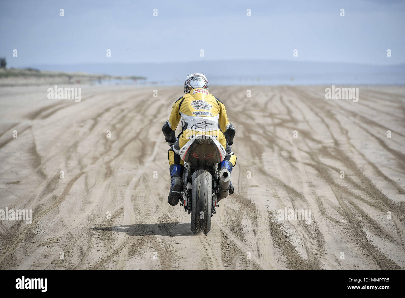 A competitor on motorbike takes part in the annual UK, European and World land speed event organised by Straightliners, at Pendine Sands, Wales, where riders and drivers of all vehicle types compete in classes for top speeds over a measured mile on the beach. Stock Photo