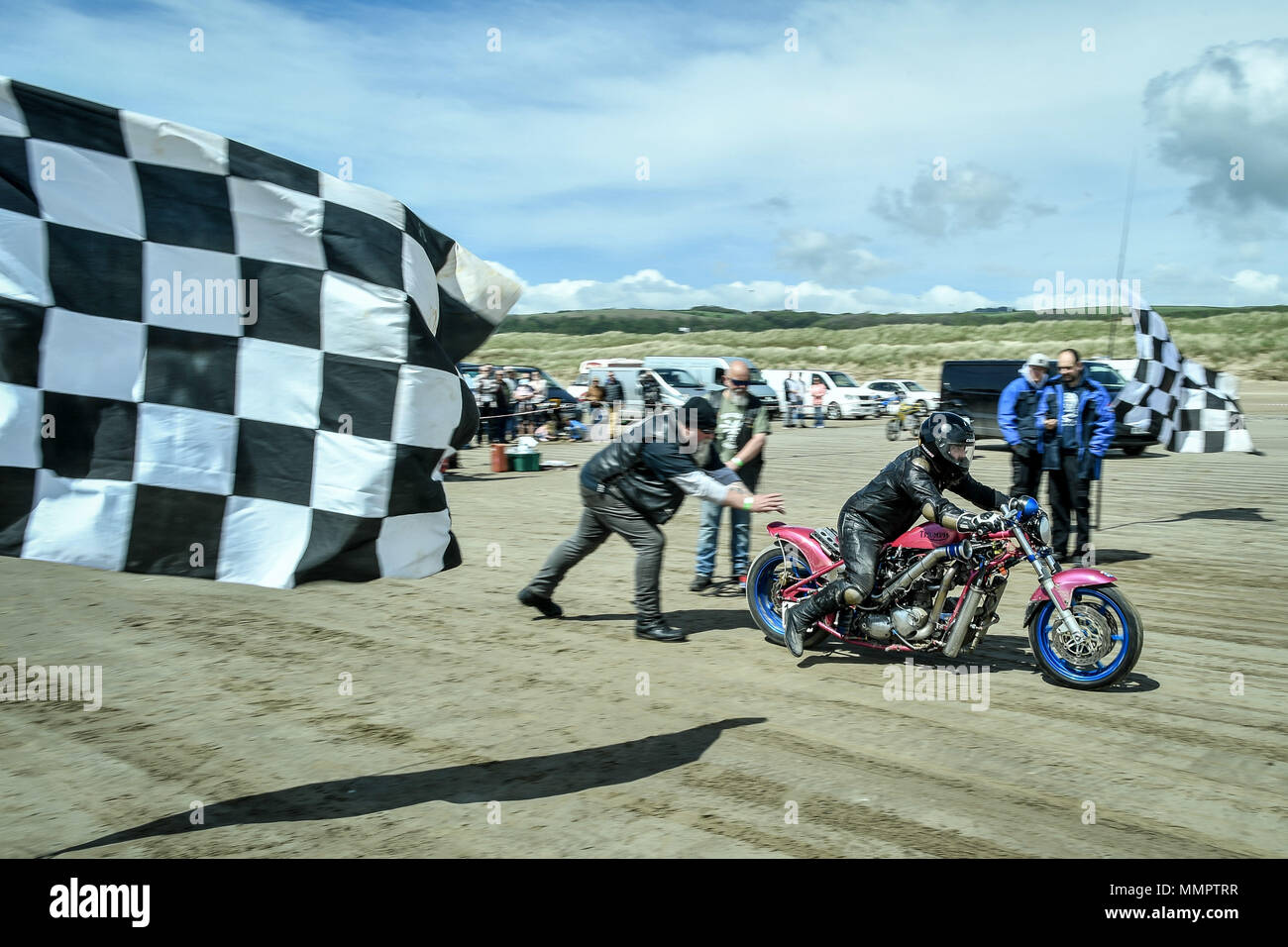 A competitor on motorbike takes part in the annual UK, European and World land speed event organised by Straightliners, at Pendine Sands, Wales, where riders and drivers of all vehicle types compete in classes for top speeds over a measured mile on the beach. Stock Photo