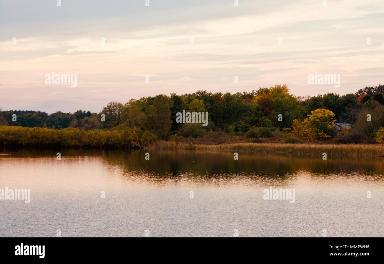 Postcard with a beautiful lake at fall on sunset Stock Photo