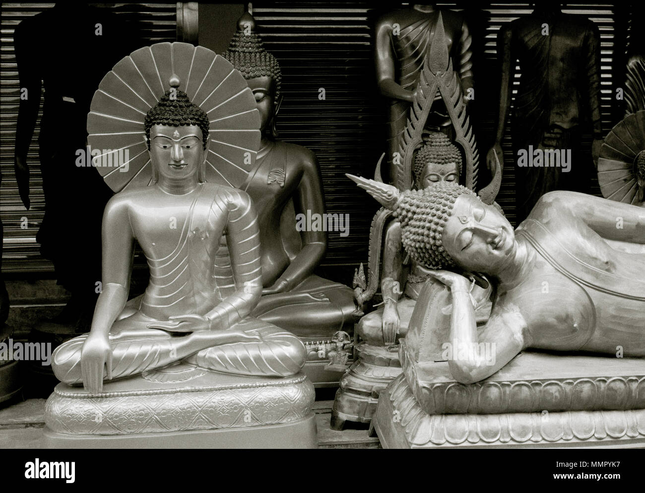 Reclining Buddha carving statue art for sale in Bamrung Muang Road in Bangkok in Thailand Southeast Asia Far East. Buddhism Buddhist Religion B&W Stock Photo