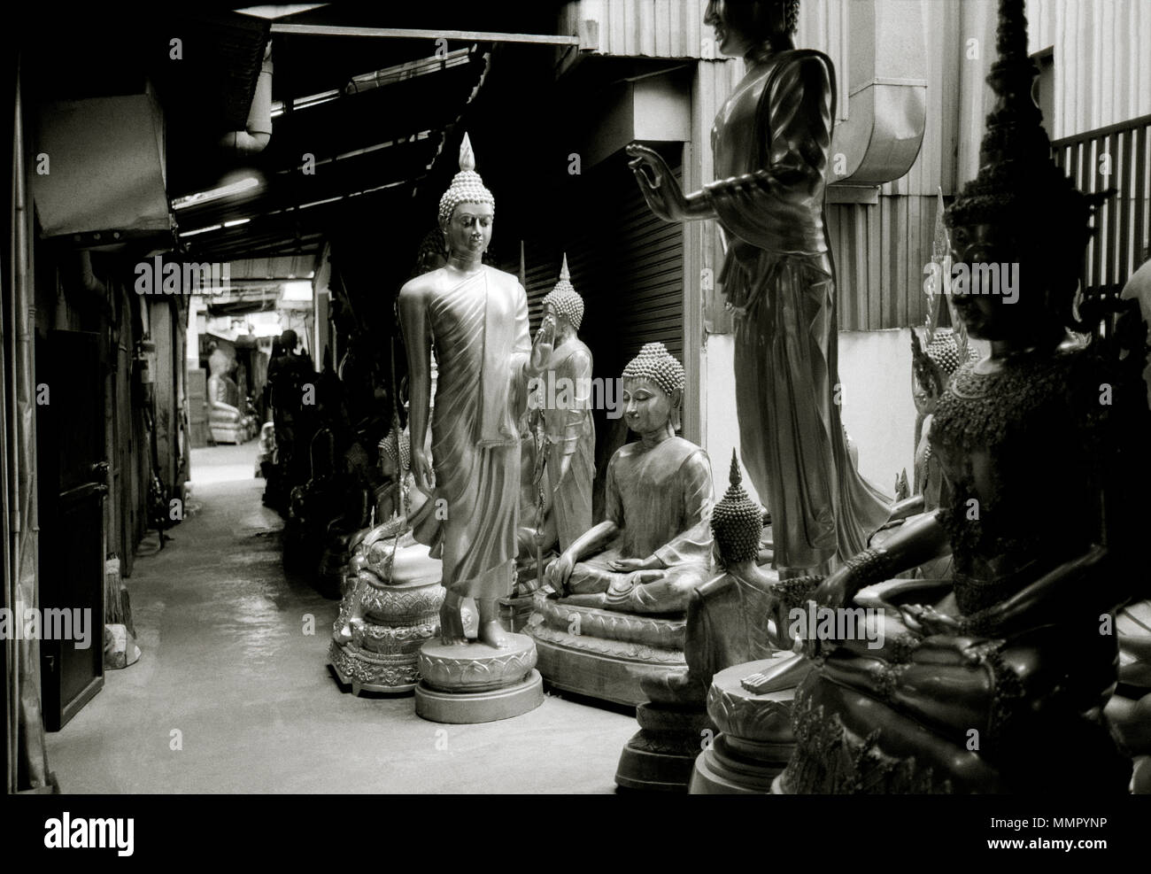Religious Buddha carving statue art for sale in Bamrung Muang Road in Bangkok in Thailand Southeast Asia Far East. Buddhism Buddhist Religion Travel Stock Photo