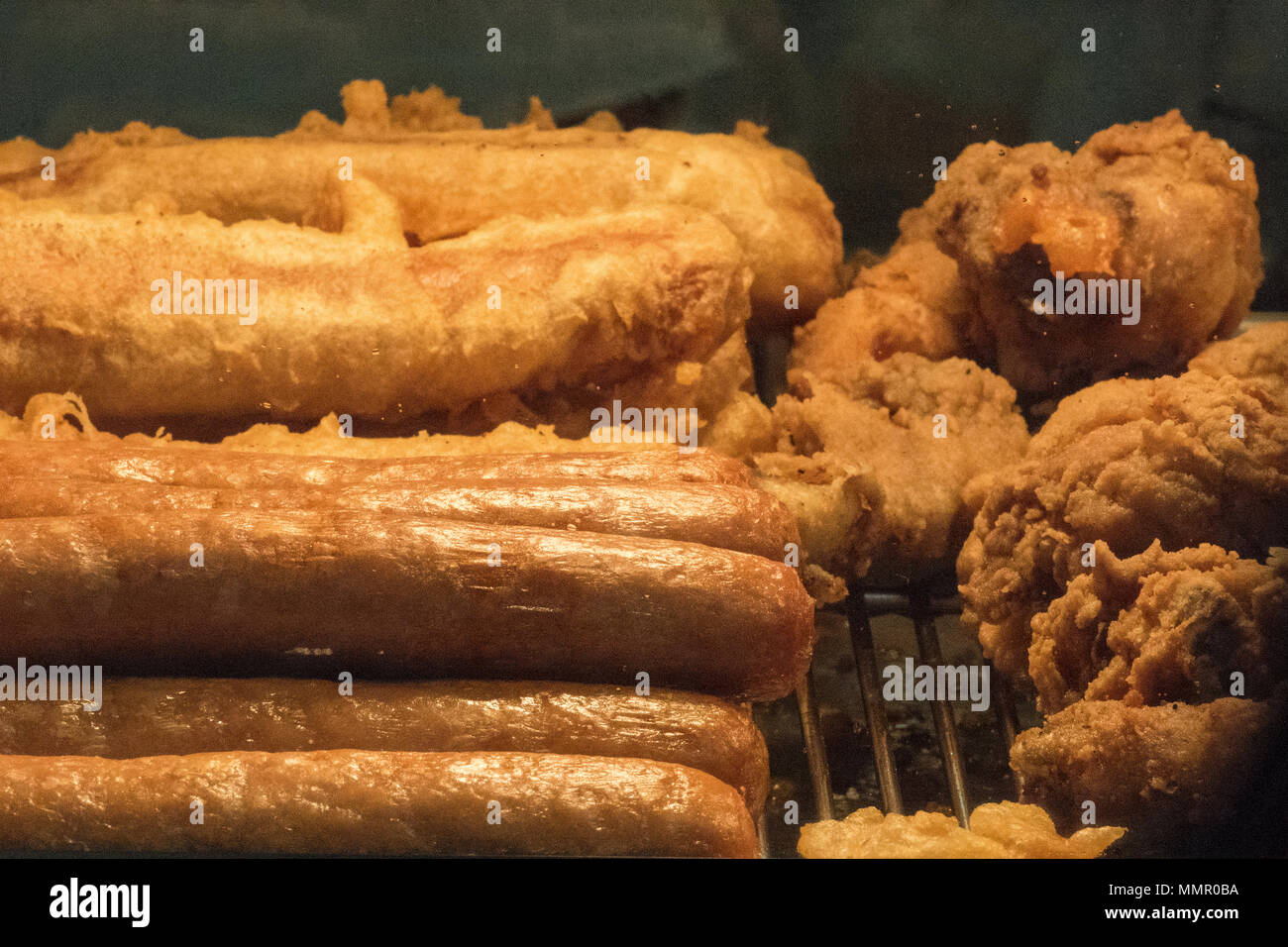 fried foods in heated counter display. Stock Photo