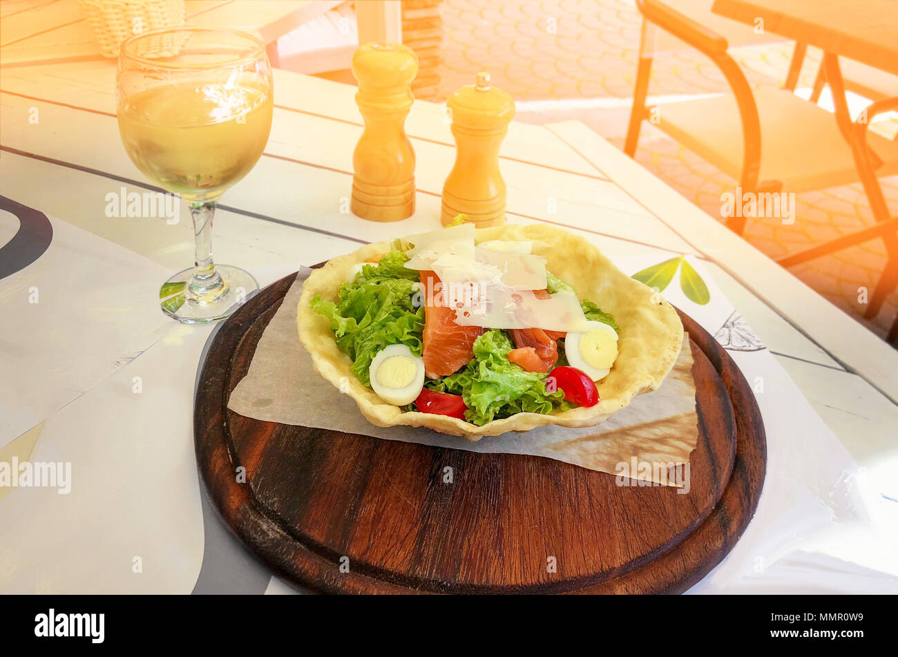 Caesar salad with tuna cheese and croutons on rustic wooden background closeup. Stock Photo