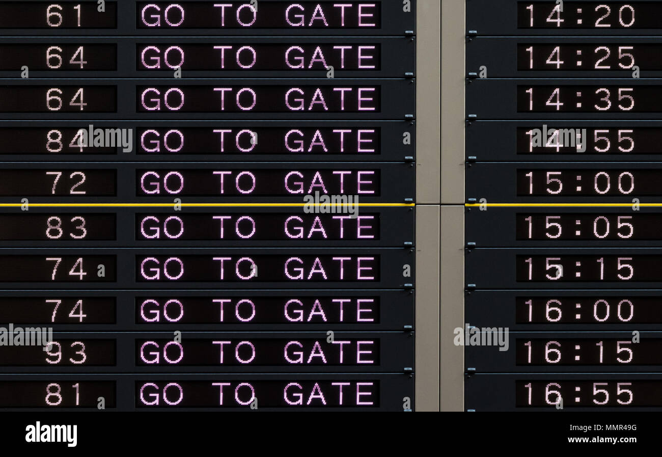 Airport departure board with go to gate sign Stock Photo Alamy