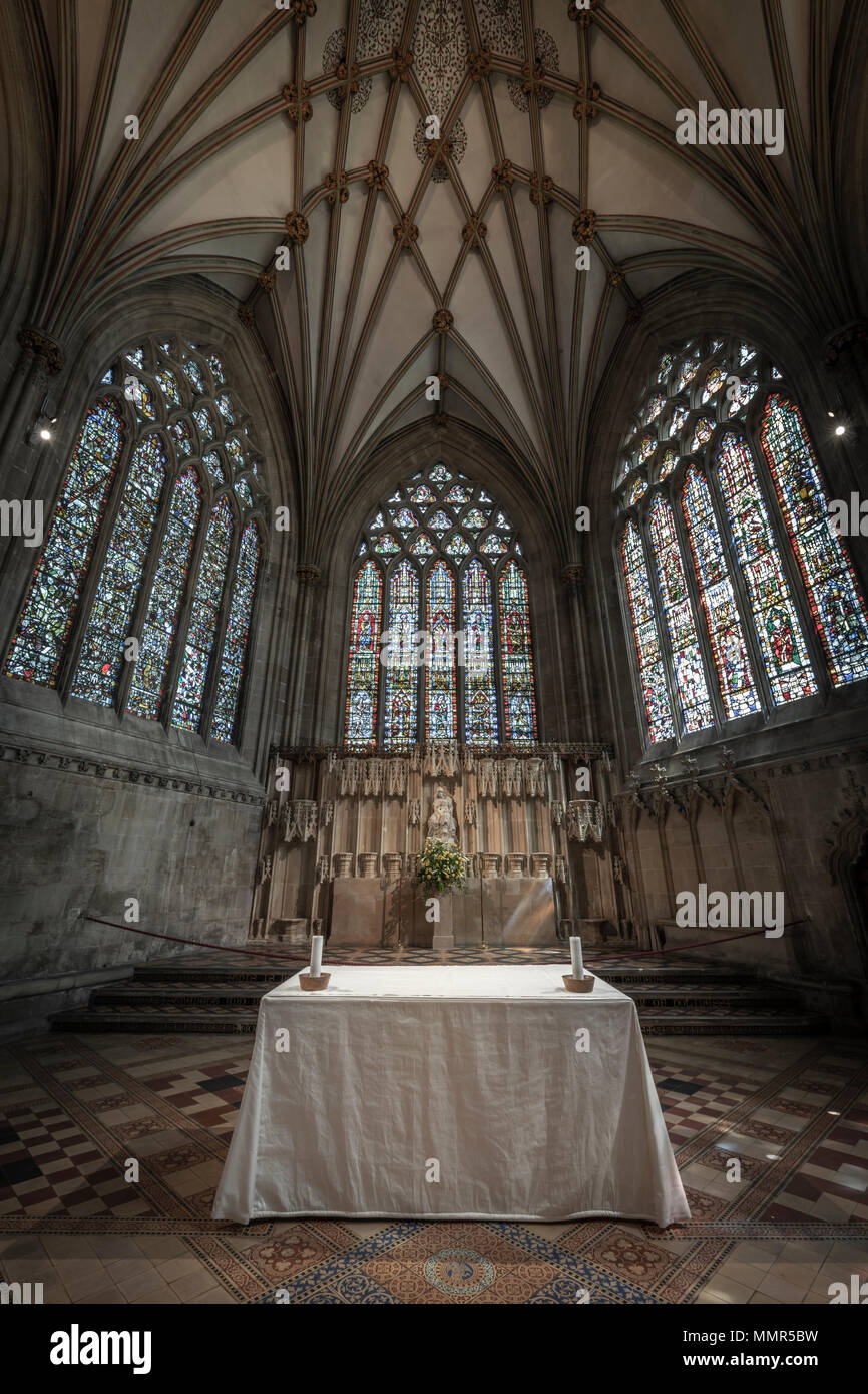 Light from the stained glass windows illuminates the  Alter table in the Lady Chapel at Wells Cathedral. Stock Photo
