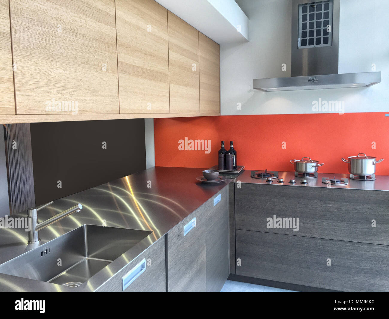 Stainless grey metal kitchen gas stove installed on a the kitchen with a  dark grey table top Stock Photo - Alamy