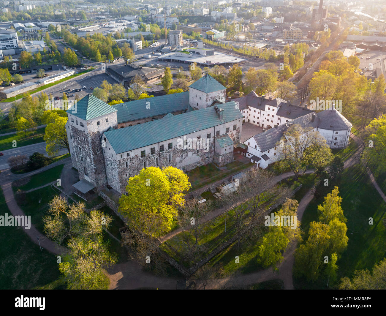 Aerial view of Turku Castle at morning sun with green springtime trees and park in Turku, Finland Stock Photo