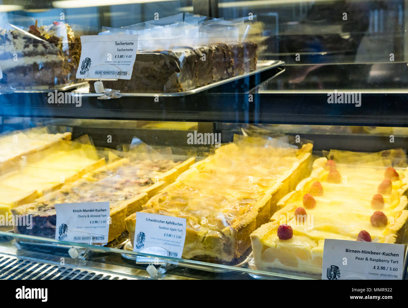 Close up of German cake display behind glass counter, Falko Konditormeister patisserie shop, Market Street, Haddington, East Lothian, Scotland, UK Stock Photo