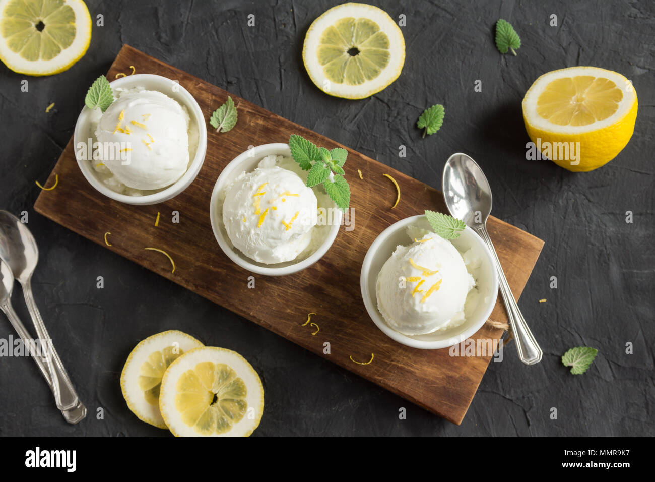 Lemon Ice Cream in bowl. Homemade citrus lemon ice cream (gelato) with mint close up. Stock Photo
