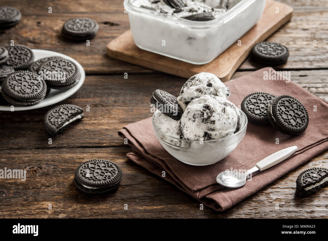Oreo ice cream. Cookies and cream homemade ice cream dessert on dark wooden background Stock