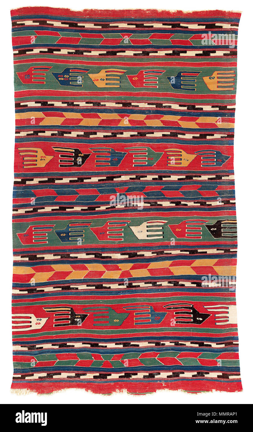 . English: Collection VOK: Anatolia 29 This beautiful kilim was attributed to West Anatolia by Herrmann, who first published it and described it in detail in 1986. Hirsch narrows down the provenance to the Canakkale-Balikesir region, proposing that the kilim was woven by local Yüncü nomads. Judging by the palette of the dividing bands which combine red and blue, red and green and red and yellow, his assumption seems reasonable. Overall colour schemes this bright and brilliant only occur in early examples. The format, too, is characteristic of Yüncü kilims. Composed of horizontal bands of varyi Stock Photo