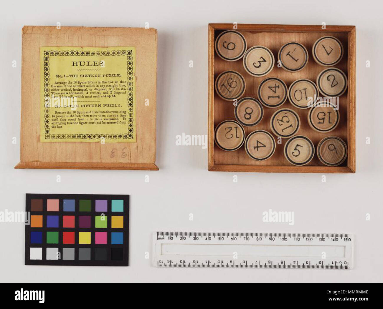 Game entitled Calculator puzzles. Two games in one; wooden box with  circular wooden blocks numbered 1-16. Label on inside of lid with rules,  printed in yellow. Box lid label printed in