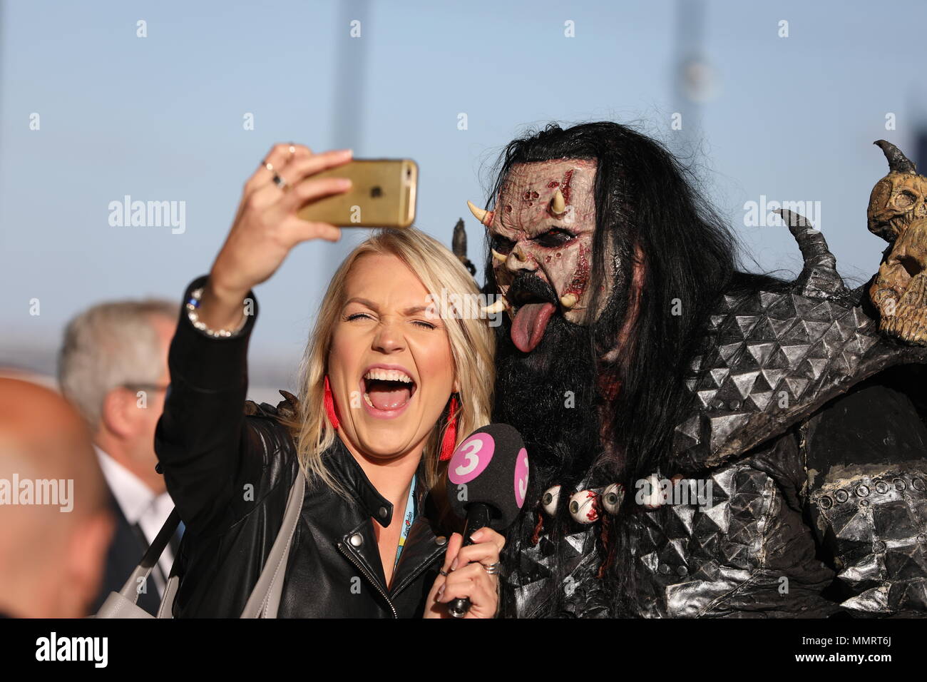 12 May 2018, Portugal, Lisbon: A television presenter takes a selfie with Mr. Lordi (Tomi Petteri Putaansuu), singer of Finnish band Lordi, shortly before the finals of the 63rd Eurovision Song Contest. Photo: Jörg Carstensen/dpa Stock Photo