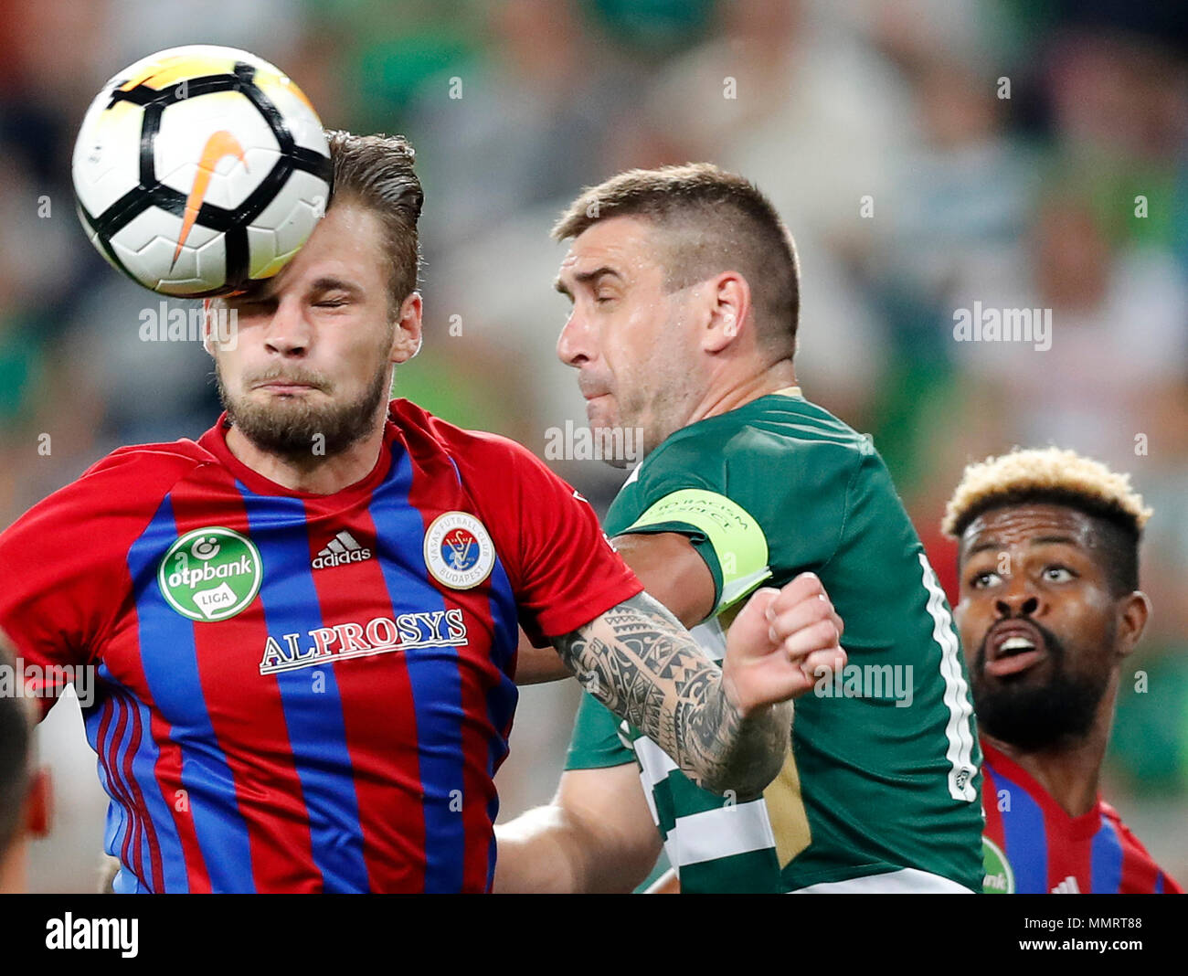 BUDAPEST, HUNGARY - MAY 12: (l-r) Vit Benes of Vasas FC wins the ball from Daniel Bode of Ferencvarosi TC in front of Manjrekar James of Vasas FC during the Hungarian OTP Bank Liga match between Ferencvarosi TC and Vasas FC at Groupama Arena on May 12, 2018 in Budapest, Hungary. Stock Photo